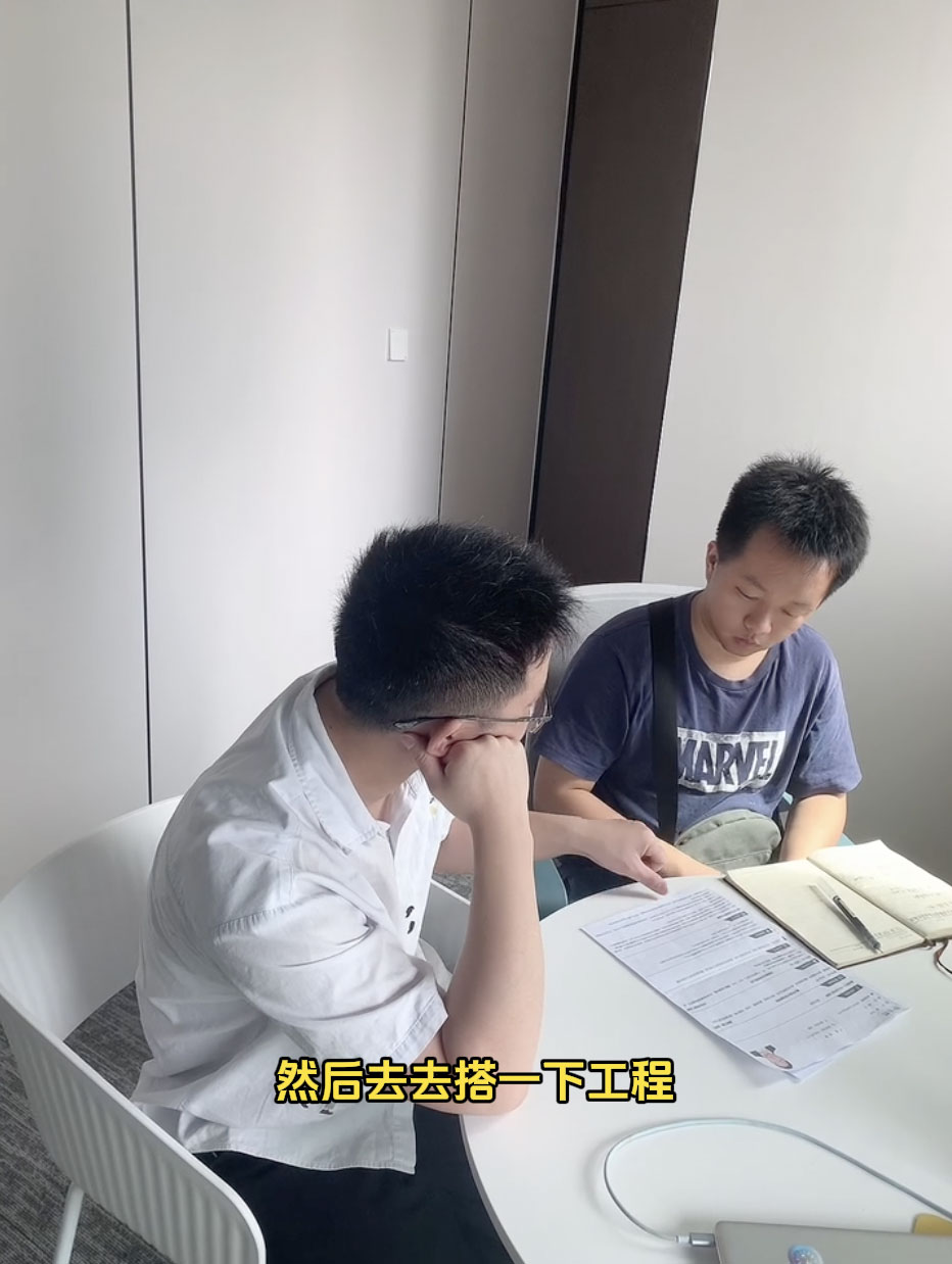 A student presenting an industrial motor control project to peers.