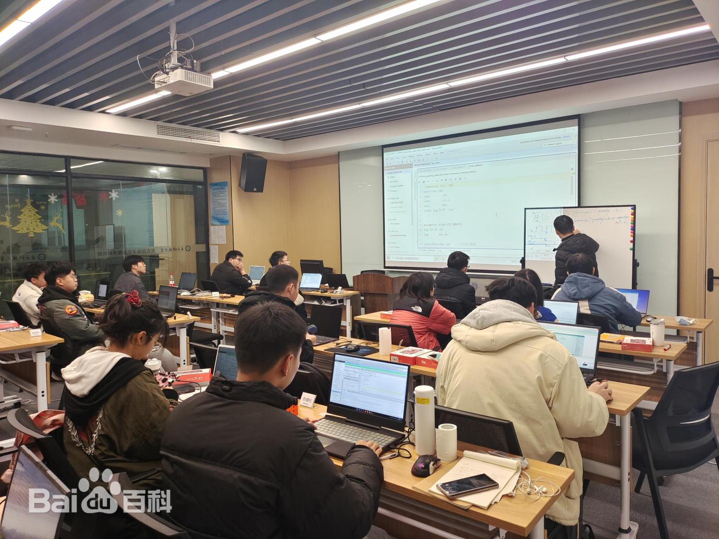 A close-up of hands working with an FPGA development board.